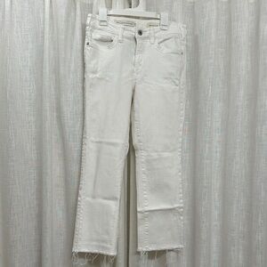 White Pilcro Jeans with a raw him. Inseam: 24 inches